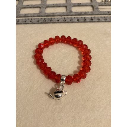 Red glass bead bracelet with teapot charm