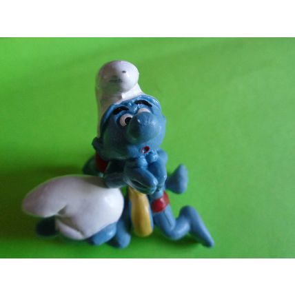 Two swimmers swimming smurfs red and yellow rubber ring