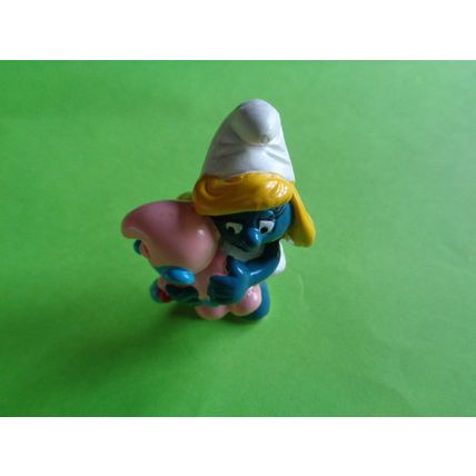 smurfette smurf holding a sleeping baby