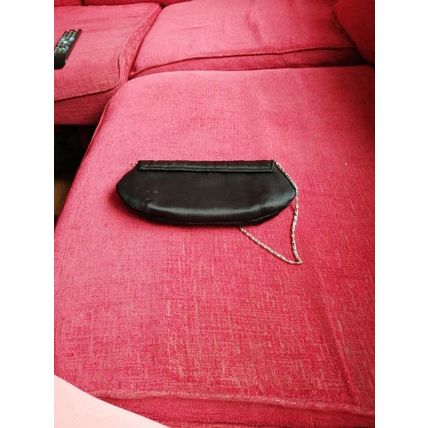 Black vintage satin clutch bag with a metal strap