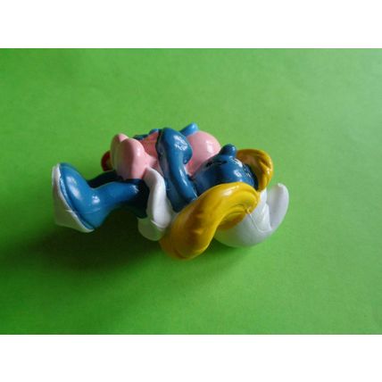 smurfette smurf holding a sleeping baby