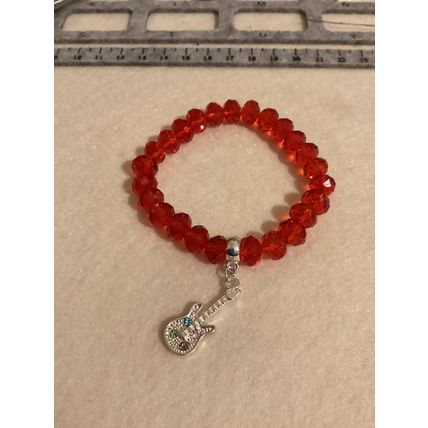 Red glass beads with guitar charm