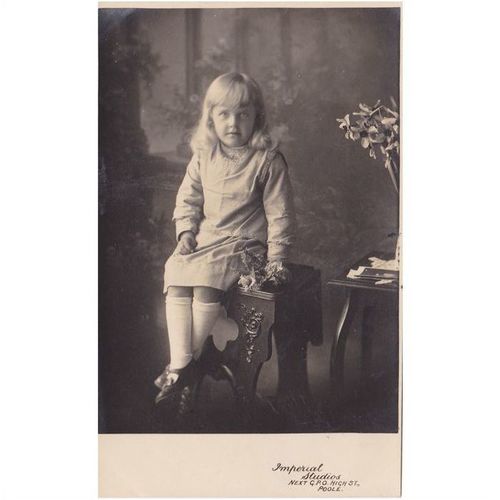 Young Girl Sitting On A Stool And Holding Flowers Postcard (SH150)