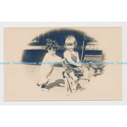 C014031 Two small children and a rocking horse. Postcard. 1918