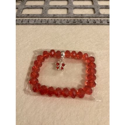 Red glass beaded bracelet with butterfly charm