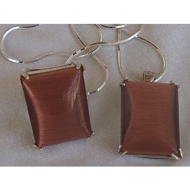 A brown cat eye set ring and pendant