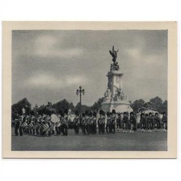 Guards passing Queen Victoria Memorial statue, London. Old souvenir snapshot