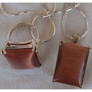 A brown cat eye set ring and pendant