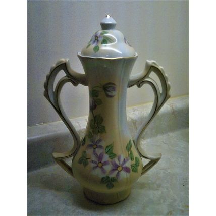 Ceramic floral design covered double handled pot