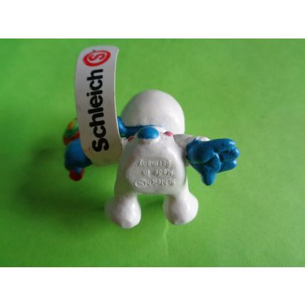 Baby smurf sitting up with rattle and label 2004