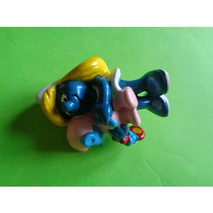 smurfette smurf holding a sleeping baby