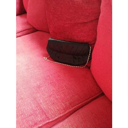 Black vintage satin clutch bag with a metal strap