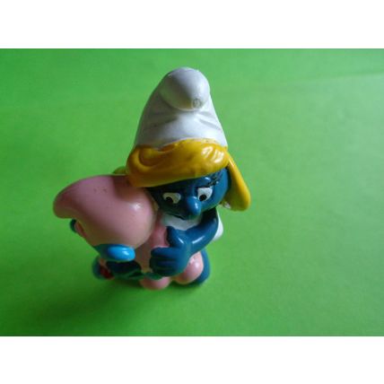 smurfette smurf holding a sleeping baby