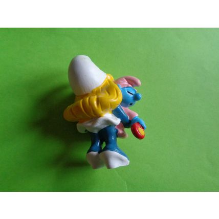 smurfette smurf holding a sleeping baby