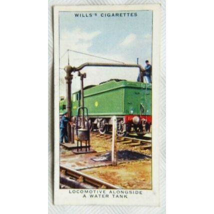 1938 Wills Railway Equipment 7 locomotive alongside a water tank