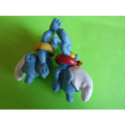 Two swimmers swimming smurfs red and yellow rubber ring