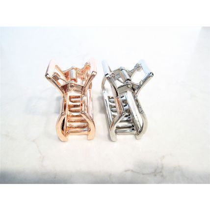 Small rose gold or silver tone metal hair claw clip
