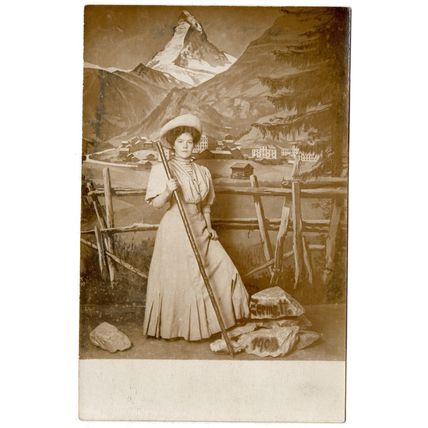 REAL PHOTOGRAPHIC SWISS STUDIO POSTCARD LADY WITH MOUNTAIN BACK-DROP (3809)
