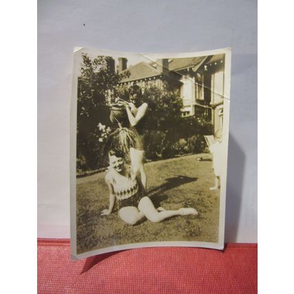 A COLD SHOWER IN THE GARDEN WITH WATERING-CAN, 1930s? photograph =