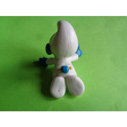 Baby smurf playing with a red toy car
