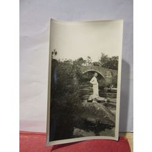 WOMAN BY BRIDGE AT RIVER DART, DARTMEET, DEVON , 1930s photograph =