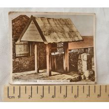 1938 hand-coloured cigarette card Old Shoeing Stocks, Herm