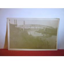 AN UNKNOWN BRIDGE SPANNIMNG A RIVER photograph =