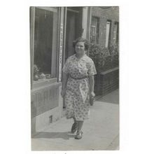Lady Walking Down Street c1935. RP Postcard.