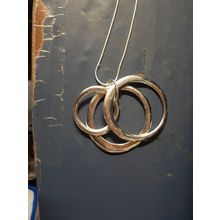 womens silver tone necklace with circular 3 piece pendant