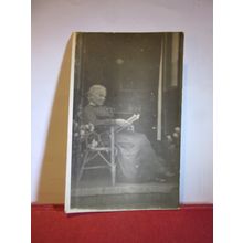 UNKNOWN ELDERLY LADY READING IN A RATTAN CHAIR, antique photograph postcard =