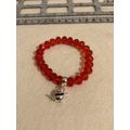 Red glass bead bracelet with teapot charm