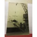 avintage crane loading/unloading a ship photogr...