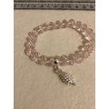 Light pink glass bead bracelet with hedgehog charm