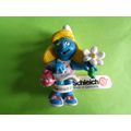 Smurfette smurf holding a flower and bag With a...