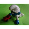 Baby smurf playing with a red toy car