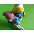 Smurfette smurf holding a pink baby and rattle ...