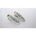 Two small blue and silver metal alligator hair ...