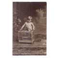 YOUNG CHILD WITH WOODEN BIRD CAGE . unused anti...