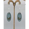 Whimsical Butterfly Resin Oval Earrings – Glittery Light Blue Elegance.