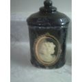Black ceramic jar with Cameo decal on front