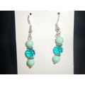 Pair of round mint blue green with faceted dark...