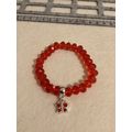 Red glass beaded bracelet with butterfly charm