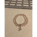 Light pink glass bead bracelet with dragonfly c...