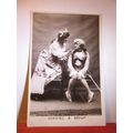 "COAXING A SMILE" used antique postcard RP by R...
