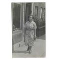 Lady Walking Down Street c1935. RP Postcard.