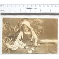 1921 postcard - Girl among the flowers