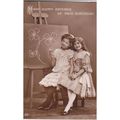 Two Young Girls Sitting By A Blackboard Postcar...