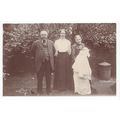 2 Ladies and a Man with Baby in Christening Gow...