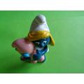 smurfette smurf holding a sleeping baby