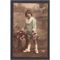 GIRL WITH FLOWERS SHOWING PERIOD FASHION STUDIO...